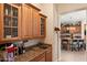 Stylish bar area with custom cabinetry, granite countertop, sink, and easy access to the kitchen at 2838 E Vaughn Ct, Gilbert, AZ 85234