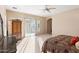 Bedroom with a large armoire, natural light from sliding glass doors, and plush carpeting at 2838 E Vaughn Ct, Gilbert, AZ 85234