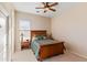 Comfortable bedroom features soft, neutral colors, a ceiling fan, and natural light from the window at 2838 E Vaughn Ct, Gilbert, AZ 85234