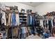 Walk-in closet with ample storage space for shoes, clothing, and boxes at 2838 E Vaughn Ct, Gilbert, AZ 85234