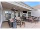 Inviting covered patio with a bar, TV, comfortable seating, and a modern outdoor heating lamp for year-round enjoyment at 2838 E Vaughn Ct, Gilbert, AZ 85234