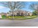 Charming single-story home with stone accents, black shutters, well-maintained lawn and manicured shrubs at 2838 E Vaughn Ct, Gilbert, AZ 85234