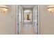 Inviting hallway features tile flooring and arched doorway, illuminated by sconce lighting at 2838 E Vaughn Ct, Gilbert, AZ 85234