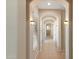 Bright hallway featuring arched doorways, tile flooring, and decorative lighting fixtures at 2838 E Vaughn Ct, Gilbert, AZ 85234