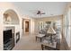 Open-concept living room with fireplace, lots of natural light and neutral color palette at 2838 E Vaughn Ct, Gilbert, AZ 85234