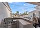 Outdoor bar with stainless steel grill looks out to lush backyard, pool, and fireplace seating area for seamless entertaining at 2838 E Vaughn Ct, Gilbert, AZ 85234