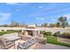 Backyard fireplace creates a warm and inviting space for outdoor gathering and entertainment in a serene setting at 2838 E Vaughn Ct, Gilbert, AZ 85234