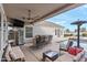 Relaxing patio area with furniture, ceiling fan, outdoor tv and a swimming pool in the backyard at 2838 E Vaughn Ct, Gilbert, AZ 85234