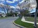 Neighborhood street view featuring well-maintained homes, sidewalks, green lawns, and mature trees under a partly cloudy sky at 2838 E Vaughn Ct, Gilbert, AZ 85234