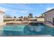 Sparkling pool boasts elegant stone accents, refreshing water features, and a built-in basketball hoop for poolside fun at 2838 E Vaughn Ct, Gilbert, AZ 85234