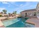 Backyard with sparkling pool, spa, fireplace, and outdoor kitchen provides a relaxing and luxurious outdoor living space at 2838 E Vaughn Ct, Gilbert, AZ 85234