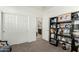 Cozy bedroom featuring a large closet, doorway to bath, and a bookshelf perfect for storage and organization at 3080 E Palmdale Ln, Gilbert, AZ 85298