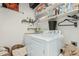 Functional laundry room featuring a modern washer and dryer, ample shelving, and a well-organized space for laundry tasks at 3080 E Palmdale Ln, Gilbert, AZ 85298