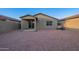 Backyard features neutral rock and covered patio, with block wall for privacy at 3225 W Fremont Rd, Phoenix, AZ 85041