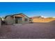 Large backyard with covered patio, rock landscaping, and block wall for privacy at 3225 W Fremont Rd, Phoenix, AZ 85041