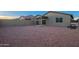 Backyard features neutral rock and covered patio, with block wall for privacy at 3225 W Fremont Rd, Phoenix, AZ 85041