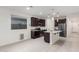 Beautiful kitchen featuring dark cabinets, stainless steel appliances, and a granite-topped kitchen island at 3225 W Fremont Rd, Phoenix, AZ 85041