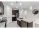 Close-up shot of the kitchen island, sink, and dishwasher with the refrigerator visible at 3225 W Fremont Rd, Phoenix, AZ 85041