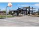 Community basketball court with hoop, benches, shaded seating, and a clubhouse in the background at 3520 E Audrey Dr, San Tan Valley, AZ 85143