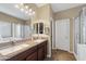 Bathroom featuring double sinks, granite countertops, and a glass-enclosed shower at 398 W Honey Locust Ave, San Tan Valley, AZ 85140