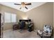 Neutral bedroom with ceiling fan, window and chair at 398 W Honey Locust Ave, San Tan Valley, AZ 85140