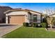 Charming single-story home featuring a two-car garage and beautiful landscaping with lush green grass at 398 W Honey Locust Ave, San Tan Valley, AZ 85140