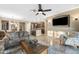 Open-concept living space with a ceiling fan, a TV set, and seamless transition to the kitchen and dining areas at 398 W Honey Locust Ave, San Tan Valley, AZ 85140