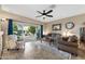 Comfortable living room featuring tile floors, a ceiling fan, sliding glass doors, and a cozy seating arrangement at 398 W Honey Locust Ave, San Tan Valley, AZ 85140