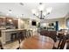 Open-concept living area featuring a kitchen island and sliding glass doors to the backyard at 398 W Honey Locust Ave, San Tan Valley, AZ 85140