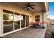 Covered patio area with chairs, a table, and sliding glass doors at 398 W Honey Locust Ave, San Tan Valley, AZ 85140