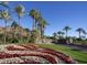 Grand entrance with lush landscaping, palm trees, and a decorative water feature at 5000 N Camelback Ridge Rd # 410, Scottsdale, AZ 85251