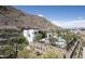 Stunning exterior showcasing modern architecture with desert landscaping, hillside views, and community pool at 5000 N Camelback Ridge Rd # 410, Scottsdale, AZ 85251