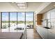Contemporary kitchen featuring a center island, stylish cabinets, and expansive windows with scenic views at 5000 N Camelback Ridge Rd # 410, Scottsdale, AZ 85251