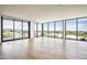 Spacious, light-filled living area with wood floors and floor-to-ceiling windows showcasing panoramic views at 5000 N Camelback Ridge Rd # 410, Scottsdale, AZ 85251