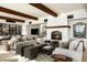 Cozy living room with a fireplace, exposed wood beams, and stylish furniture creating a comfortable and inviting atmosphere at 5000 N Camelback Ridge Rd # 410, Scottsdale, AZ 85251