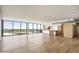 Bright, open-concept living room with wood floors and expansive windows offering stunning city views at 5000 N Camelback Ridge Rd # 410, Scottsdale, AZ 85251