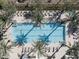 Aerial view of a luxurious pool area surrounded by palm trees and lounge chairs, creating a relaxing oasis at 5000 N Camelback Ridge Rd # 410, Scottsdale, AZ 85251