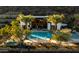 Resort style pool with palm trees, lounge chairs, and a luxurious pool surrounded by lush landscaping at 5000 N Camelback Ridge Rd # 410, Scottsdale, AZ 85251