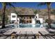 Inviting pool area surrounded by palm trees and modern architecture, perfect for relaxation and luxury living at 5000 N Camelback Ridge Rd # 410, Scottsdale, AZ 85251