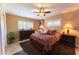 Cozy bedroom with a ceiling fan, window shutters, and carpet at 508 W Harmont Dr, Phoenix, AZ 85021