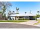 Charming single-story home with desert landscaping, a covered carport, and a light gray color scheme at 508 W Harmont Dr, Phoenix, AZ 85021