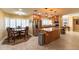 Well-lit eat-in kitchen featuring stainless steel appliances, granite countertops, and a cozy dining area at 508 W Harmont Dr, Phoenix, AZ 85021