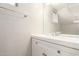 Clean bathroom showcasing a white vanity with sink and large mirror on a well-lit wall at 510 N Alma School Rd # 266, Mesa, AZ 85201