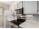 Well-lit kitchen featuring stainless steel appliances including a microwave, stove, and refrigerator at 510 N Alma School Rd # 266, Mesa, AZ 85201