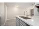 Bright kitchen featuring a quartz countertop island with a stainless steel sink and faucet at 510 N Alma School Rd # 266, Mesa, AZ 85201