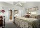 Bright bedroom with neutral colors and a ceiling fan, offering views into the connected bathroom at 5440 W Voltaire Dr, Glendale, AZ 85304