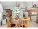 Cozy dining area adjacent to the kitchen, featuring a vintage light fixture and a view into the kitchen at 5440 W Voltaire Dr, Glendale, AZ 85304