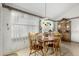 Cozy dining area featuring a vintage light fixture and a large window at 5440 W Voltaire Dr, Glendale, AZ 85304