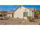 Side view of charming single-story home with low maintenance desert landscaping, neutral paint, and an attached two-car garage at 5440 W Voltaire Dr, Glendale, AZ 85304