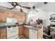 Well-maintained kitchen with laminate countertops, white appliances, and ample cabinet space at 5440 W Voltaire Dr, Glendale, AZ 85304